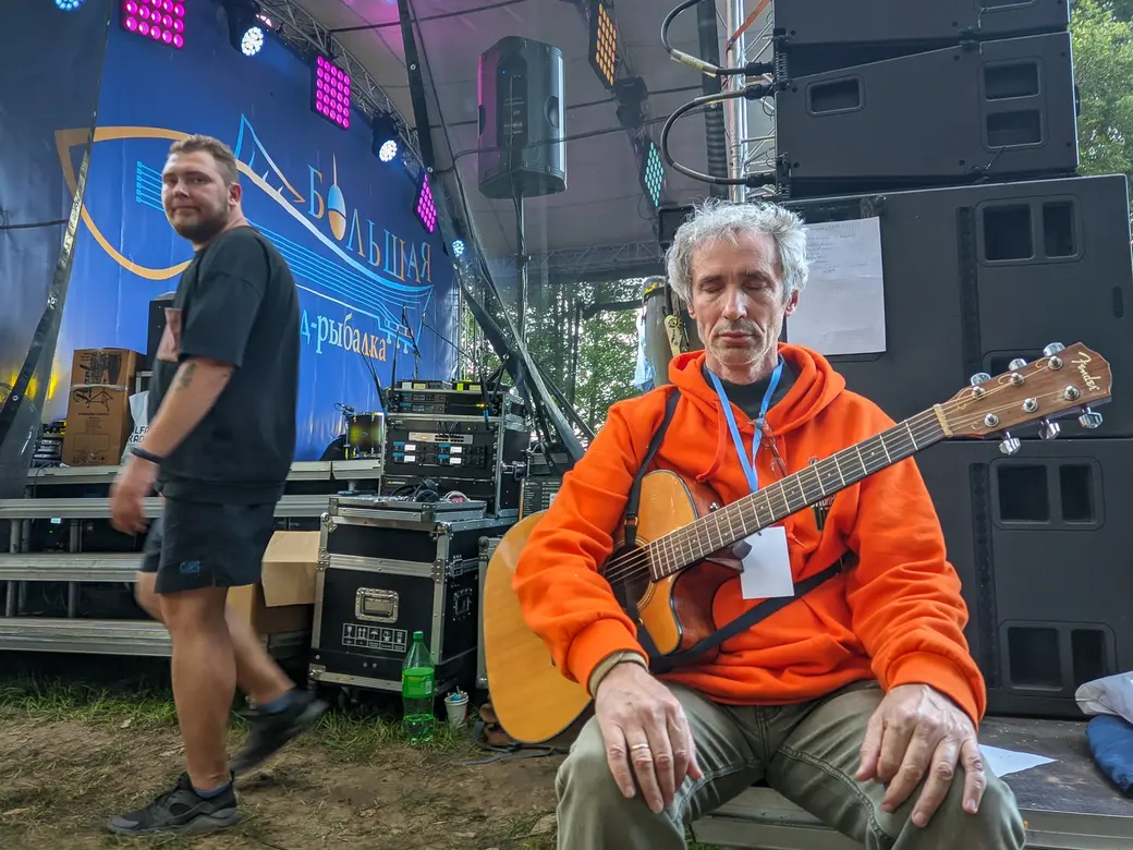 30.07.2022. Черноборский сельский Совет. Вадим Кусков (Новосибирск) медитирует перед выходом на сцену. Областной музыкальный фестиваль «Большая бард-рыбалка» прошел в