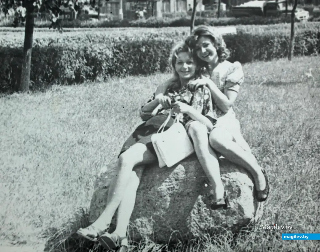 Диана Гранковская с подругой в сквере, напротив дома №85 на углу Ленинской и проспекта Мира, рядом с зданием Дома Советов (Могилевского облисполкома). Середина 1970-х.