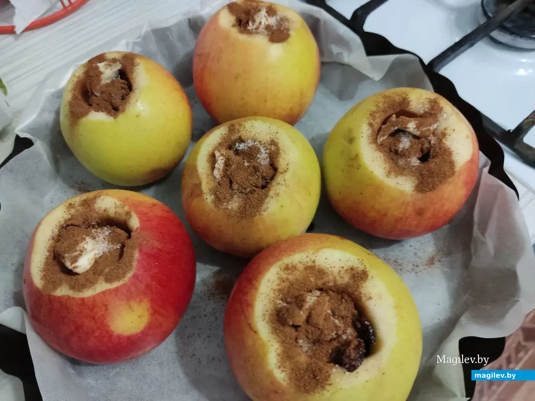 Сверху кладем в каждое яблоко небольшой кусочек сливочного масла и щедро посыпаем корицей.